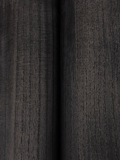 Close-up of dark charcoal wood-grain wallpaper with a central vertical seam; panel-style veneer finish.