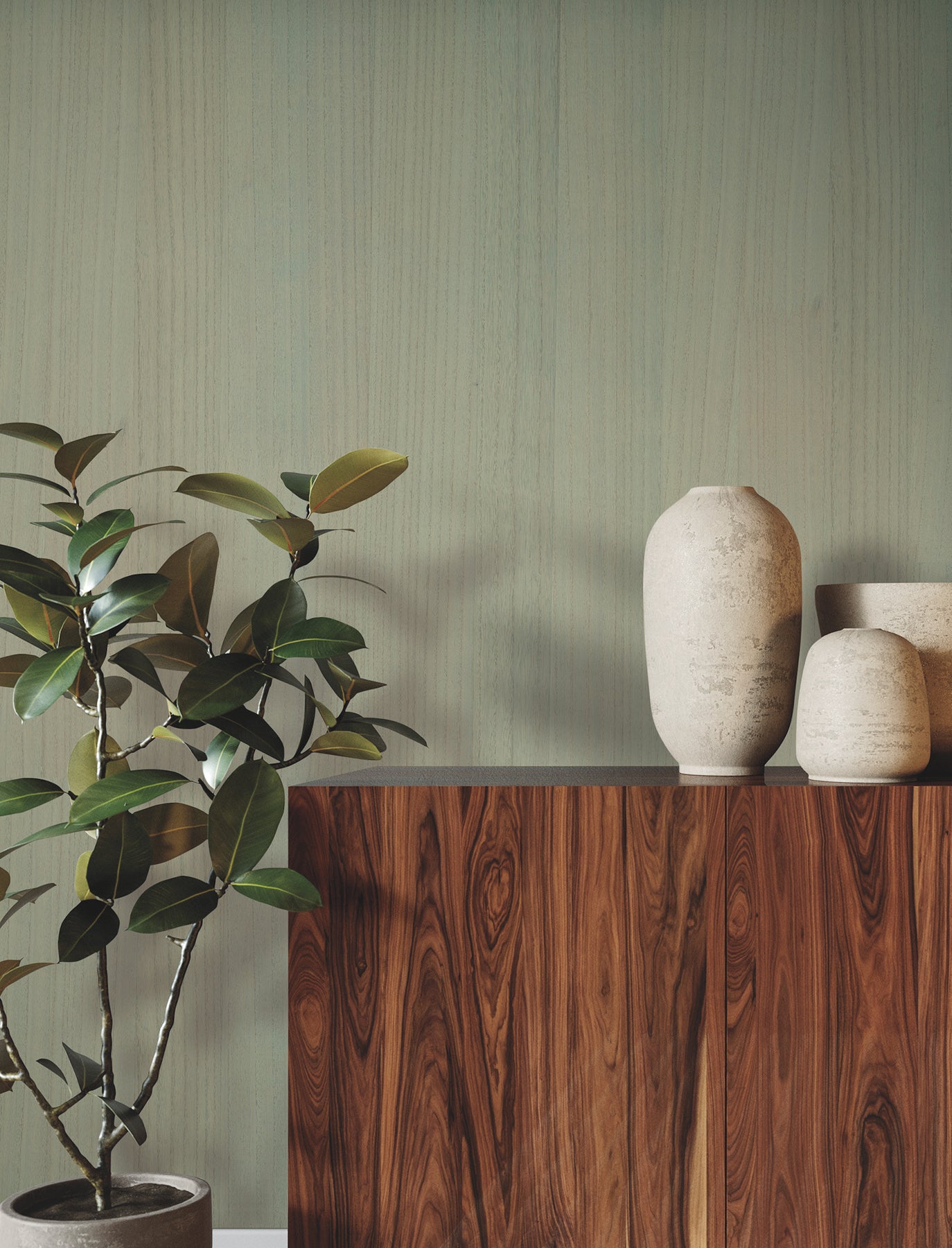 Dark wood sideboard with tall white ceramic vases and a leafy houseplant against a sage-green wall.