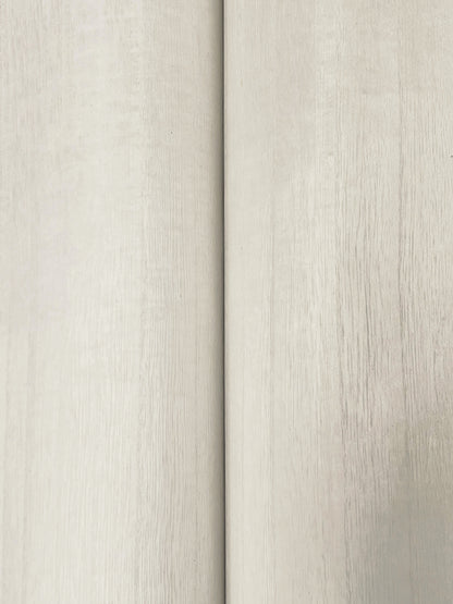 Close-up of light beige wood-veneer wallpaper with subtle grain and a narrow vertical seam.
