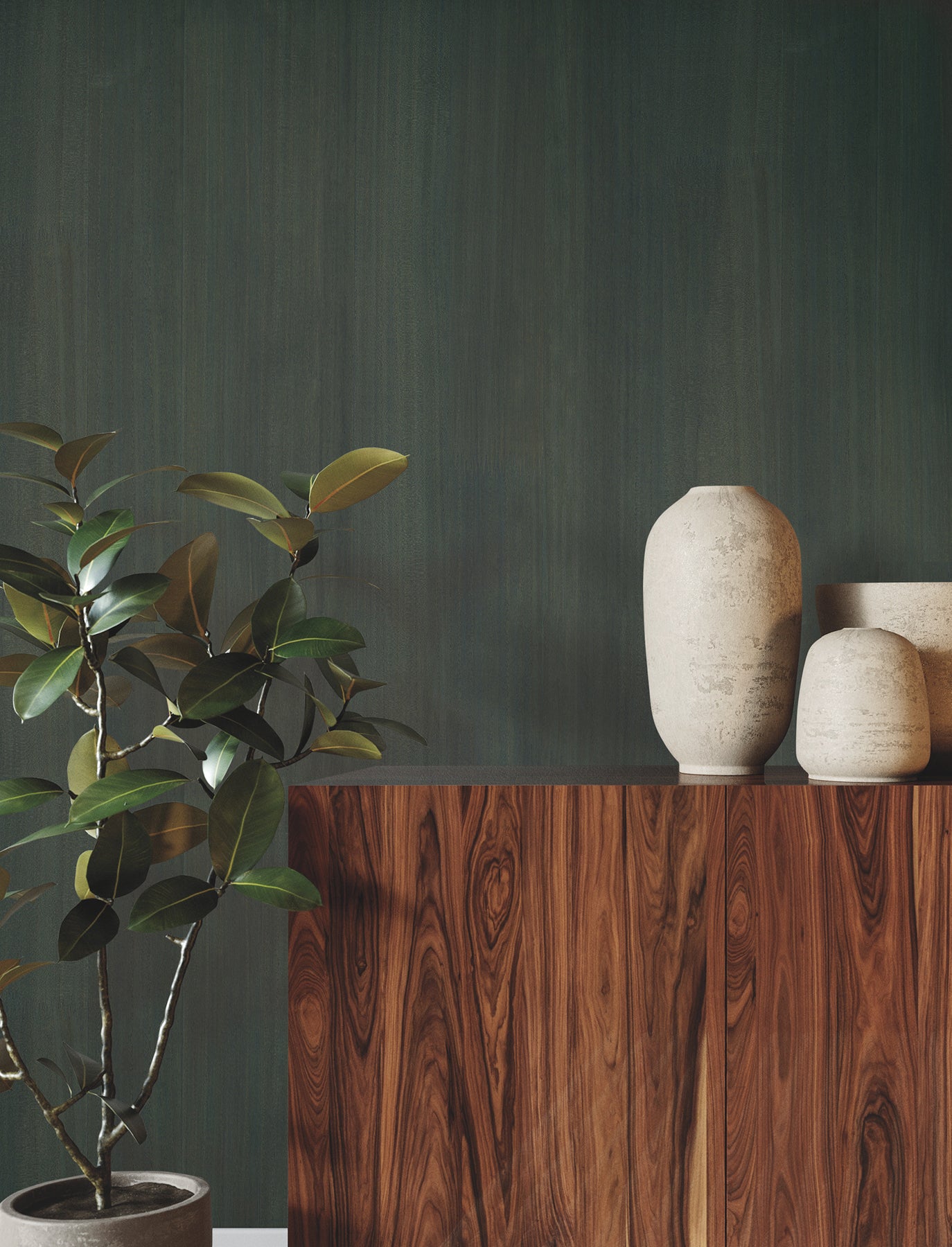 Dark green wall behind a walnut wood sideboard with beige ceramic vases and a leafy potted plant.