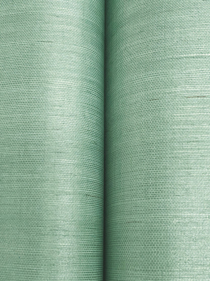 Close-up of two sage green linen-textured fabric rolls, woven pattern and soft matte finish, ideal for upholstery.