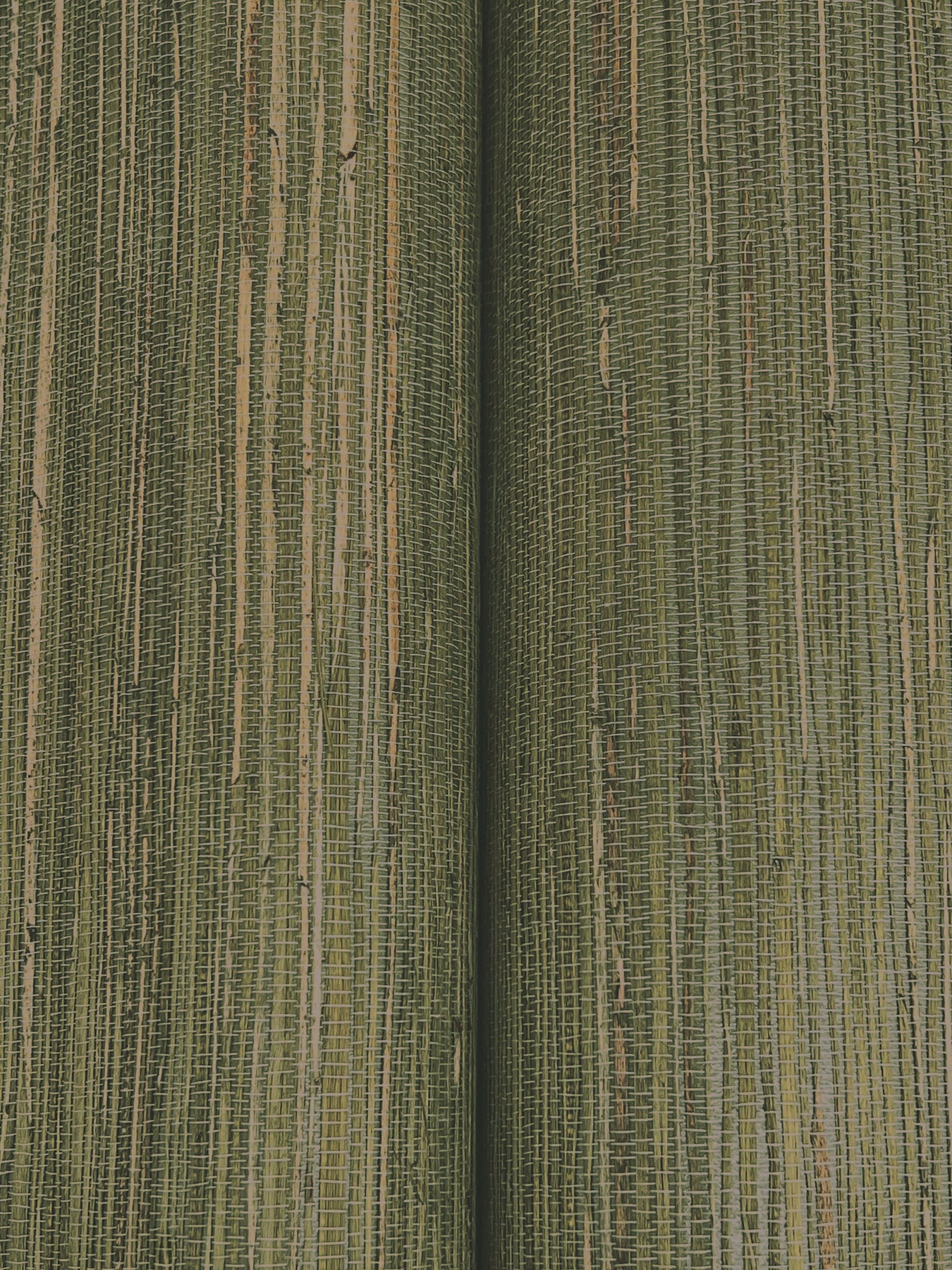 Close-up of olive green woven fabric with a central seam and narrow vertical ribbing.