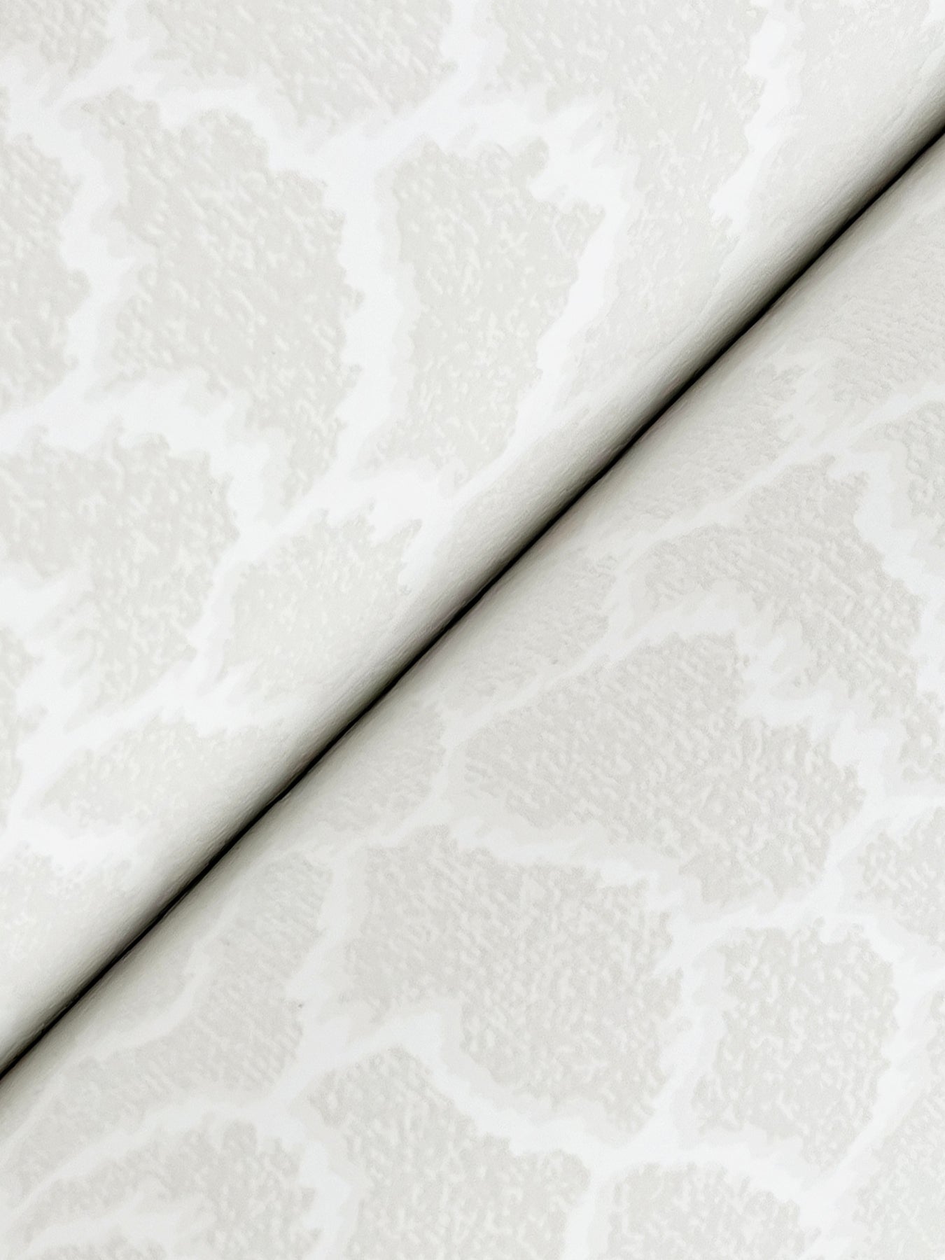Ivory damask-patterned wallpaper with a subtle floral motif in whites and off-whites.