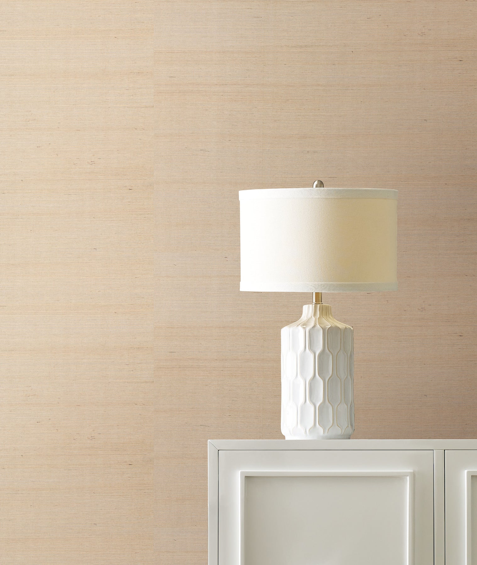 Beige grasscloth wallpaper with a subtle sisal texture on the wall.