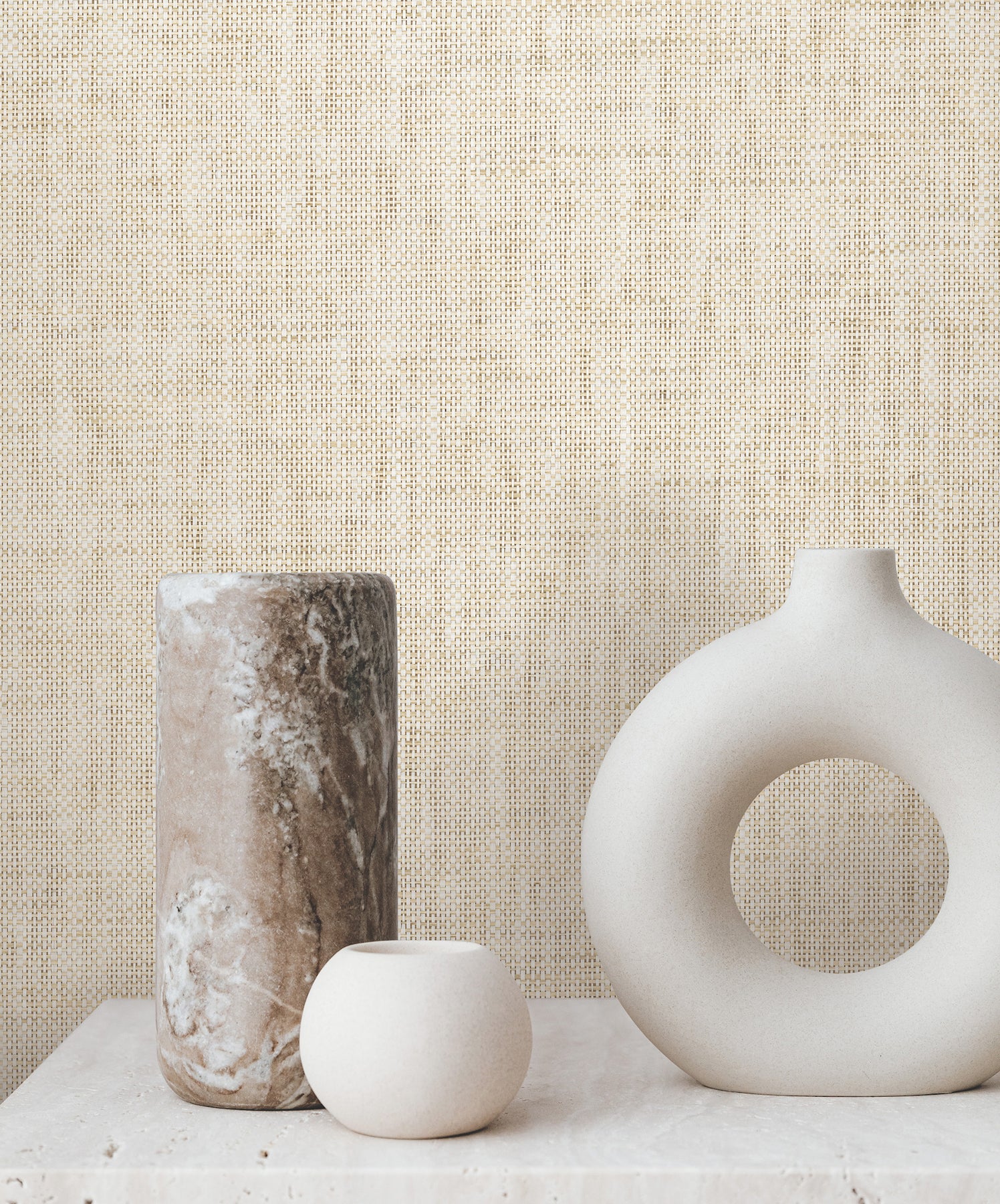Beige grasscloth wallpaper with natural Paperweave texture on a wall.
