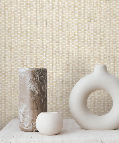 Beige grasscloth wallpaper with natural Paperweave texture on a wall.