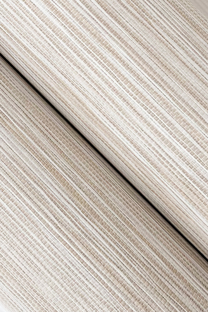 Beige striped grasscloth wallpaper close-up showing a woven texture with a ribbed appearance and diagonal seam.