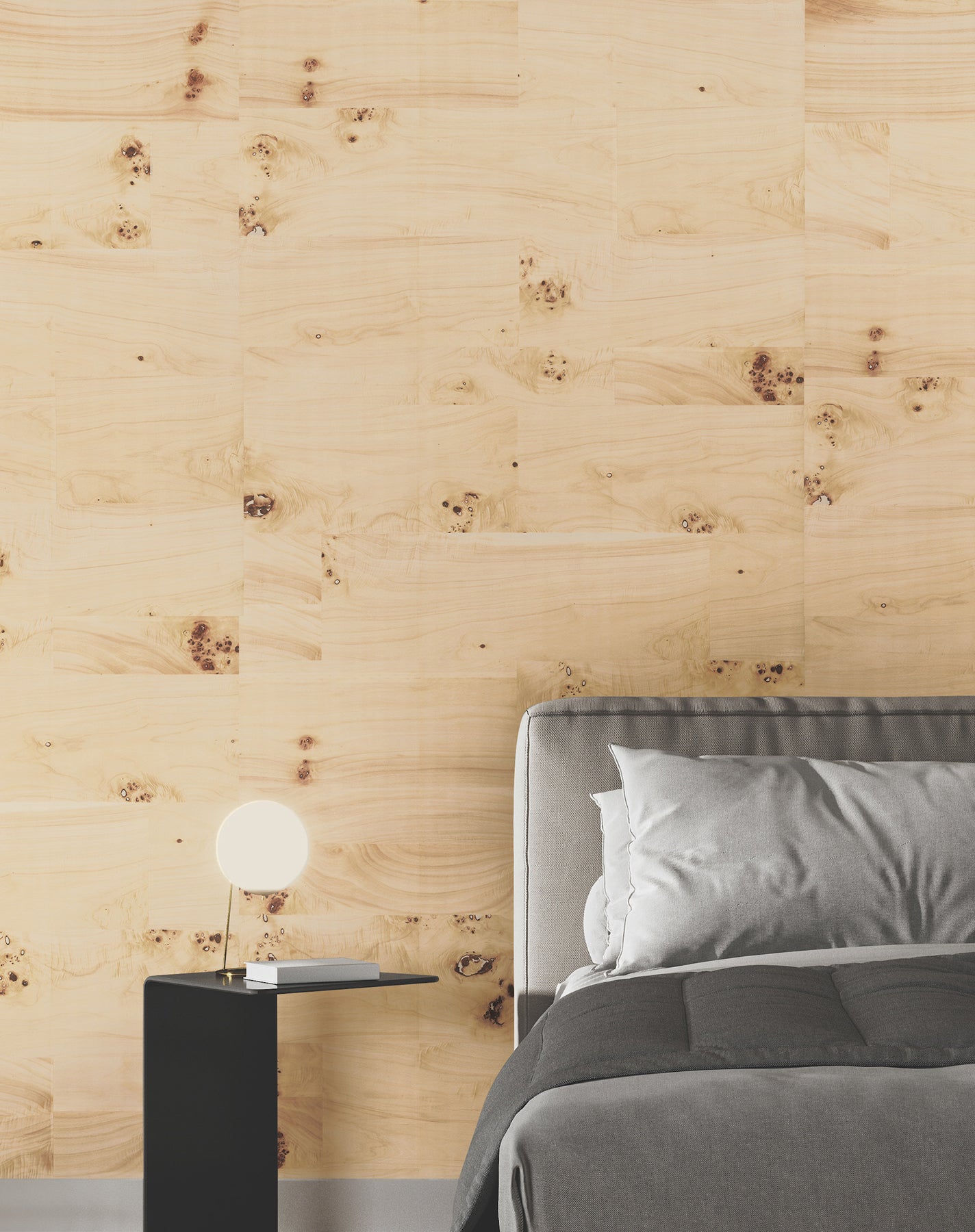 Bedroom feature wall covered with Burlwood natural wood veneer wallpaper in beige tones; a gray upholstered bed with gray bedding and a black nightstand are in the scene.