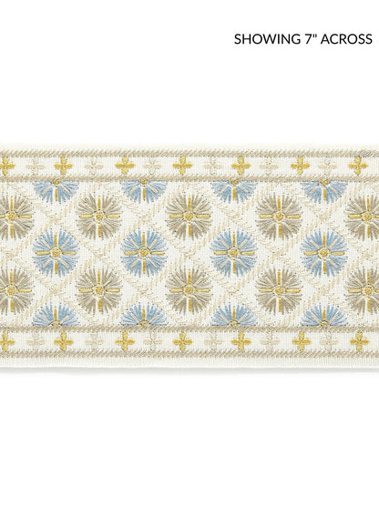Beige embroidered tape fabric with gold sunbursts and pale blue accents, edged with gold crosses.