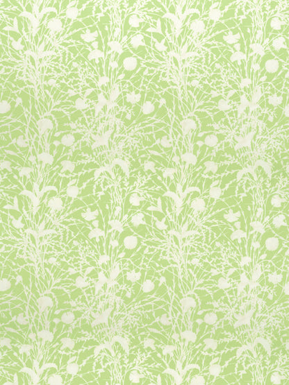 Lime green fabric with white botanical motif of tall grasses and seed heads in a seamless repeating pattern.