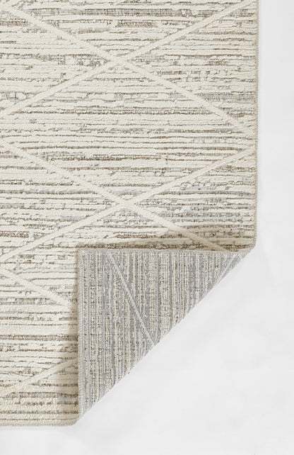 Beige geometric area rug with crisscross diamond pattern; folded corner reveals striped underside.