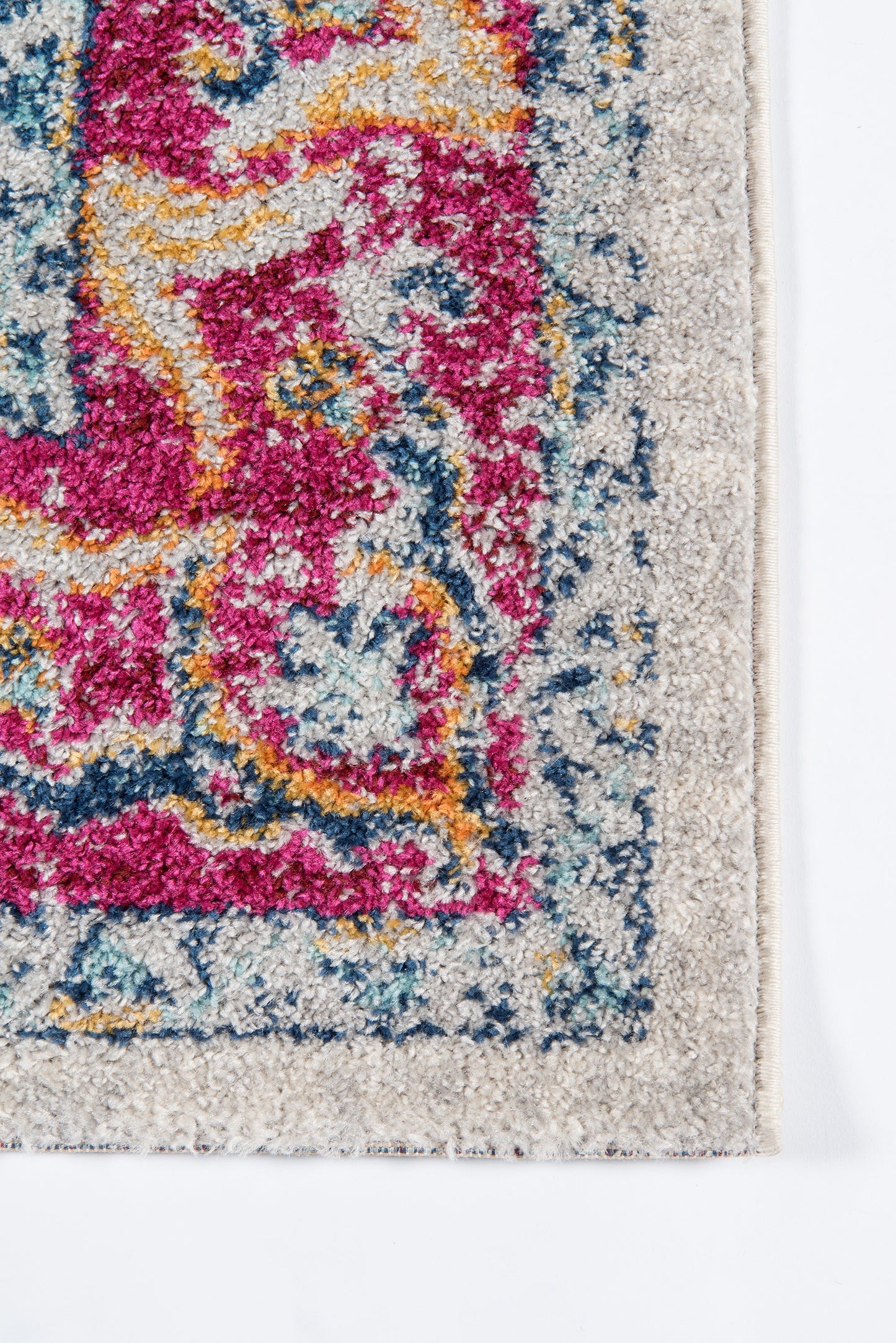 Vibrant oriental-inspired rug with pink, teal, blue and yellow motifs, beige border, dense cut-pile.