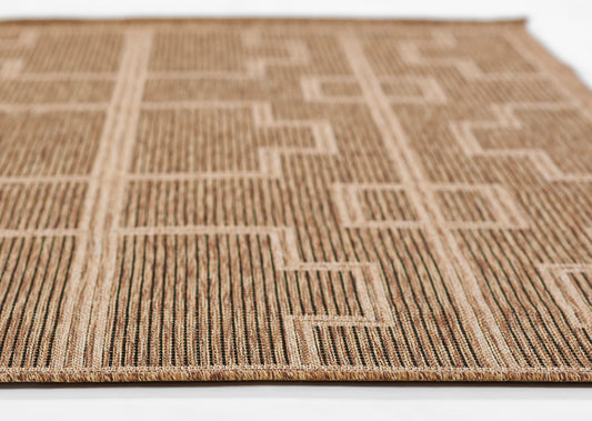 Natural jute rug with beige-brown geometric rectangles and vertical stripe motif; flat-weave with braided edge
