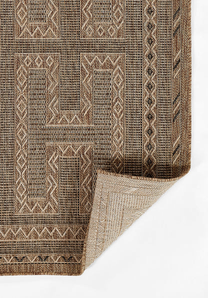 Natural brown and tan geometric flatweave rug with diamond borders, folded corner.
