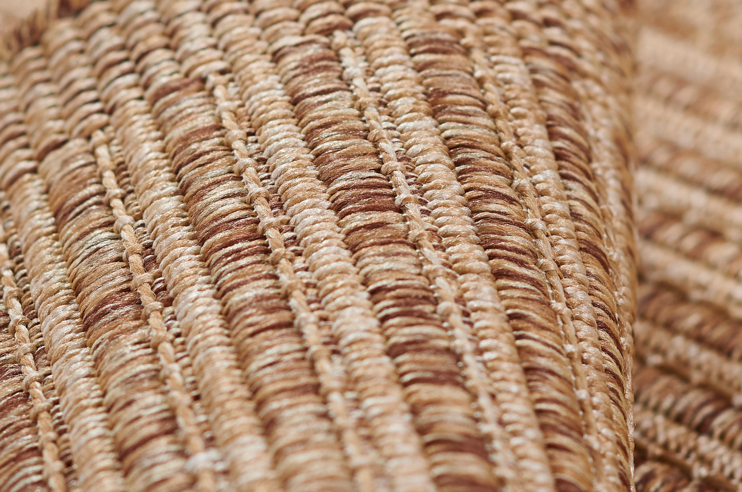 Close-up of natural beige-brown braided jute weave; rustic woven rug texture.