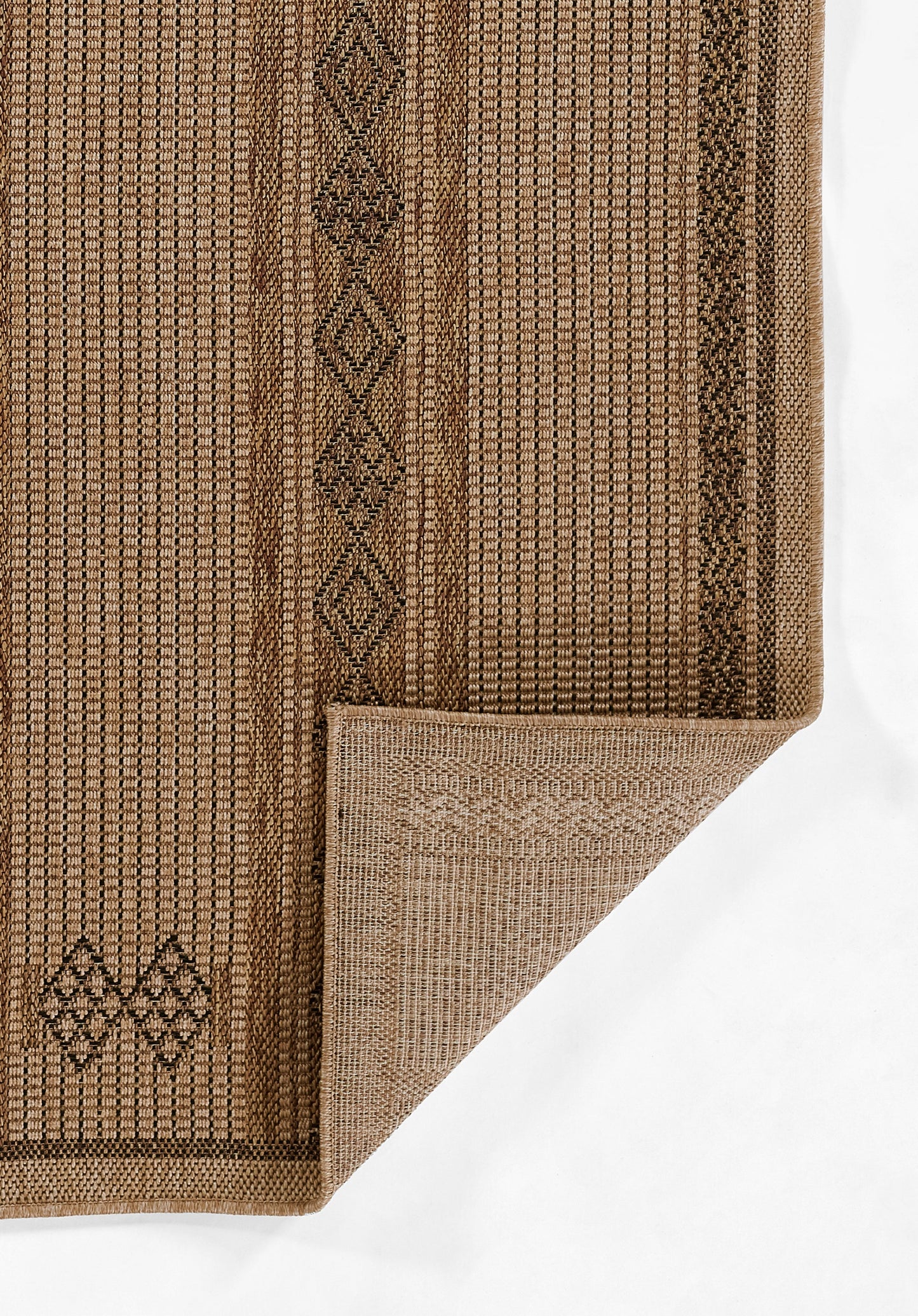 Natural brown jute rug with geometric diamond border, textured weave, folded corner.