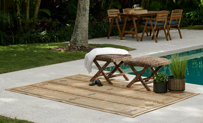 Beige woven outdoor rug, 4' x 6', laid poolside.