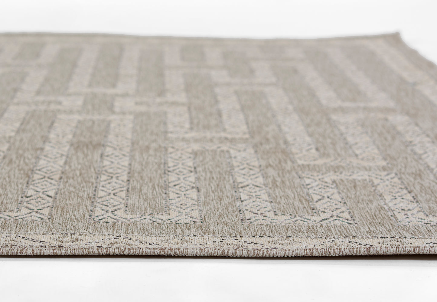 Beige-gray geometric rug runner with rectangular patterns, stitched border, and textured low-pile weave.