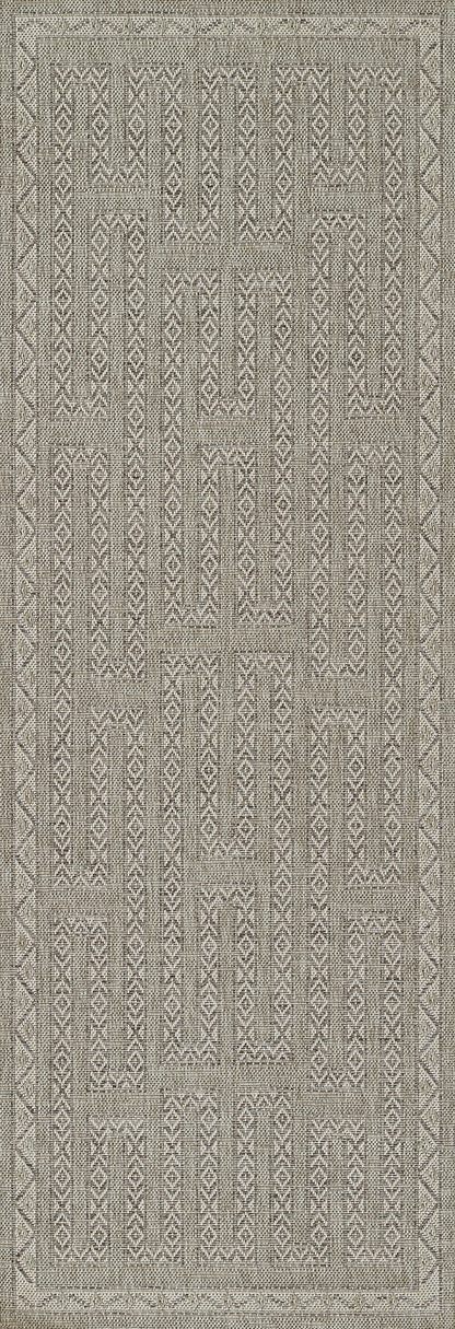 Gray geometric flat-weave rug with patchwork blocks and tribal motifs, bordered for a rustic-modern vibe.