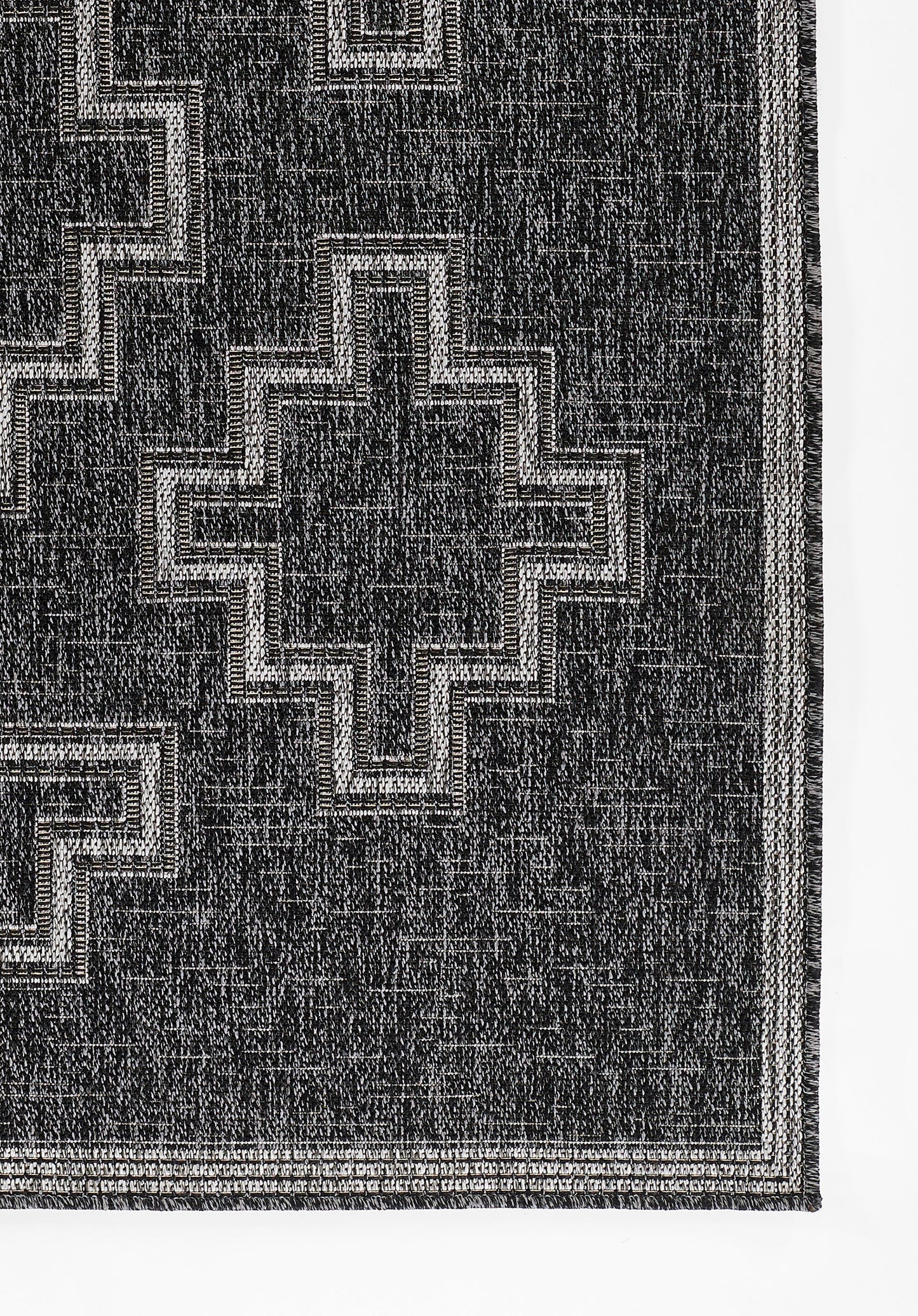Black rectangular rug on a gray gradient backdrop.