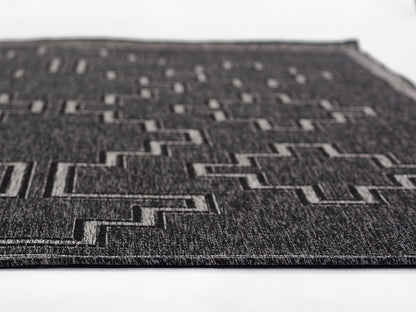 HAMPOHAM-9BLK black geometric rug with stepped rectangular pattern in light gray, flat-weave texture.