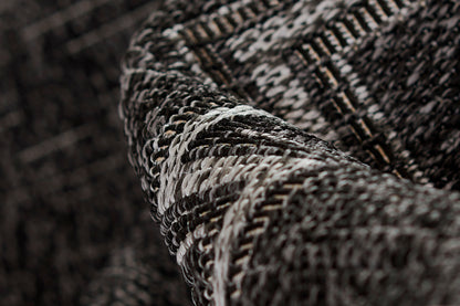 Dark gray and black tweed rug close-up with white flecks and chunky woven texture; size 2' X 3'.