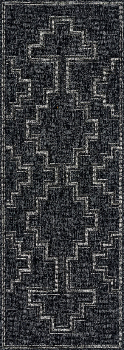 Charcoal gray rectangular rug runner with light gray stepped cross geometric pattern; modern tribal style.