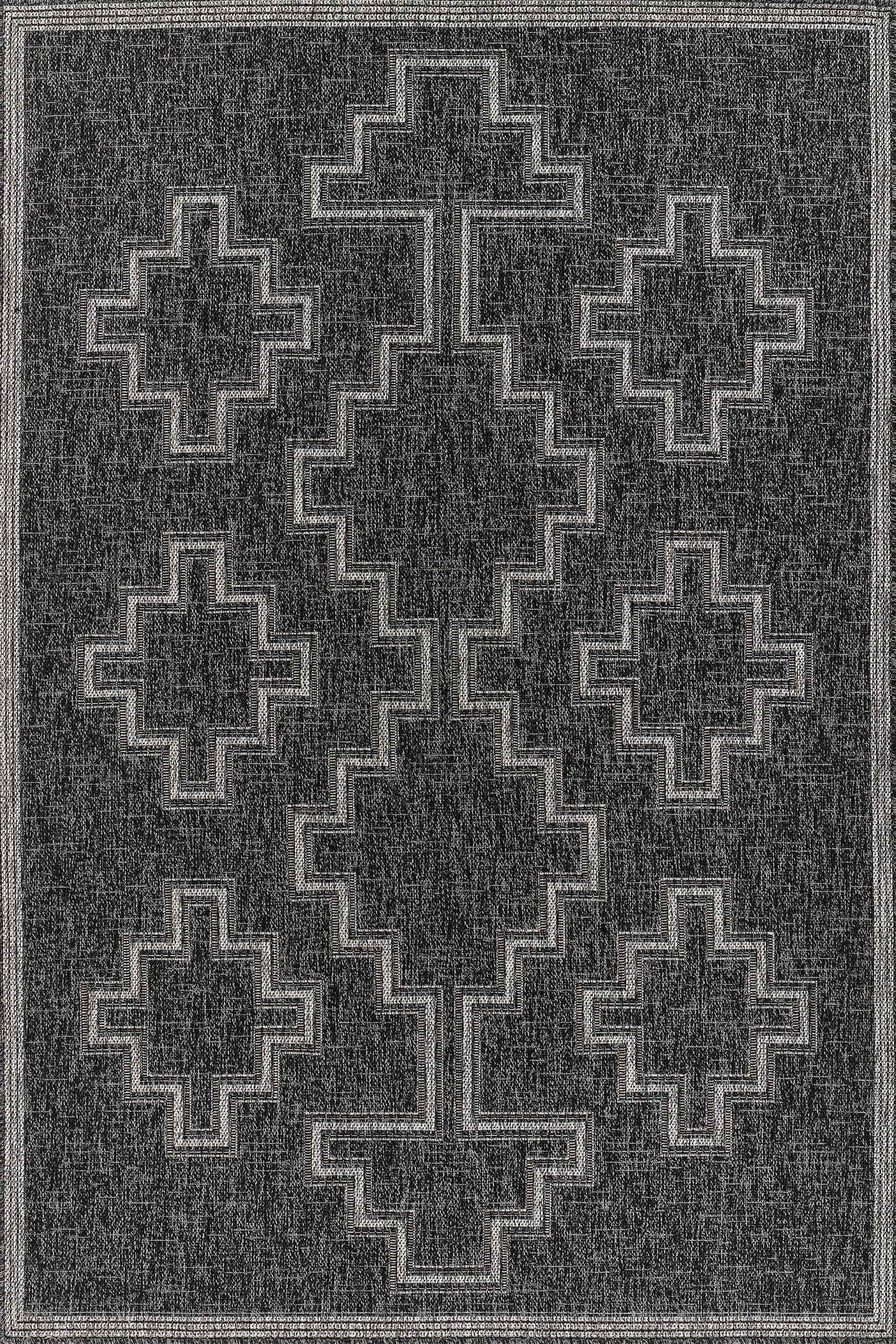 Charcoal rug with light gray stepped cross/diamond pattern and bordered frame; tribal geometric design.