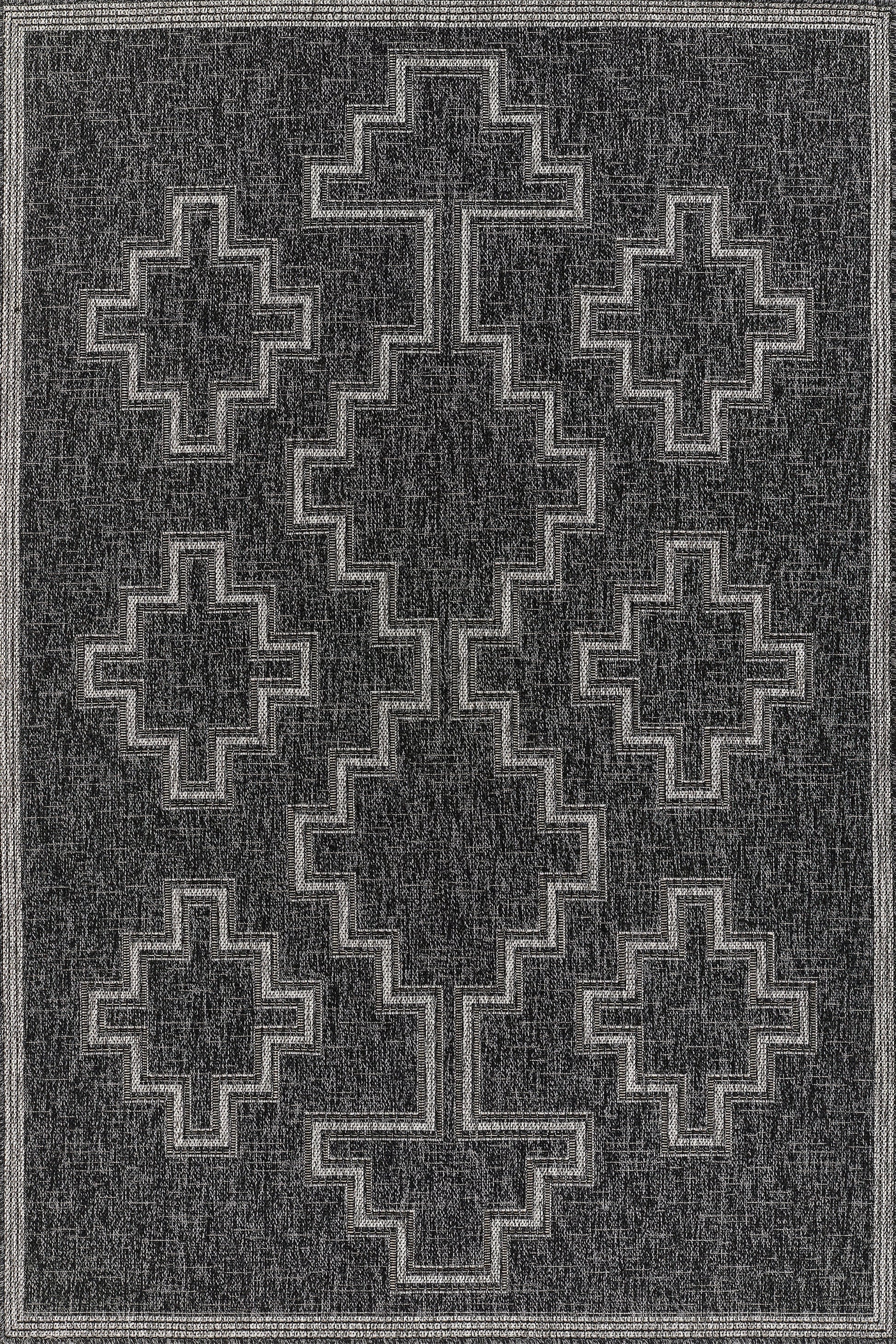 Charcoal rug with light gray stepped cross/diamond pattern and bordered frame; tribal geometric design.