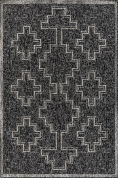 Charcoal rug with light gray stepped cross/diamond pattern and bordered frame; tribal geometric design.