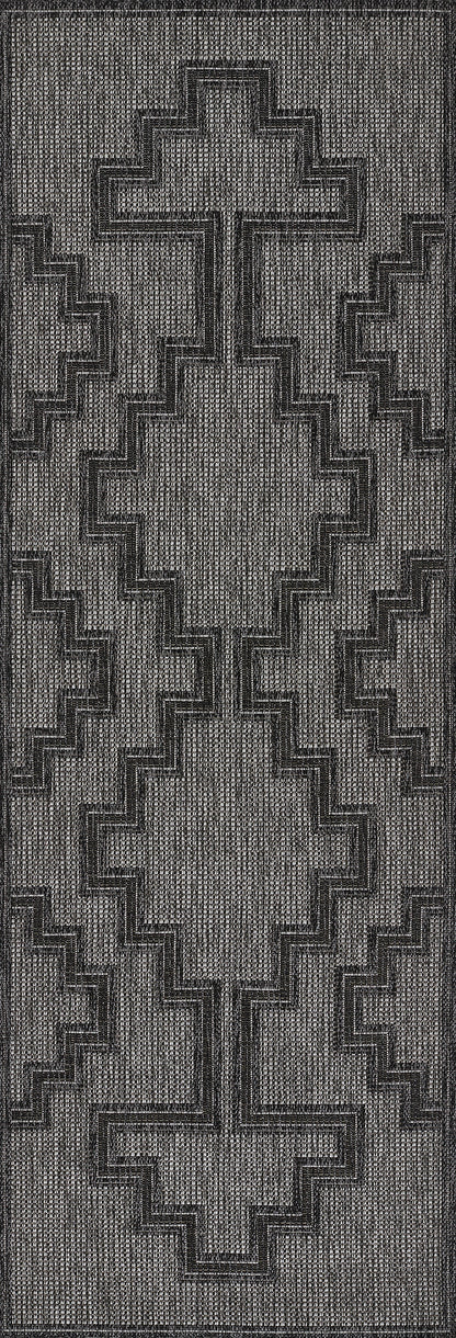 Gray woven rug with bold stepped cross motif in black, textured geometric design for modern floor decor.