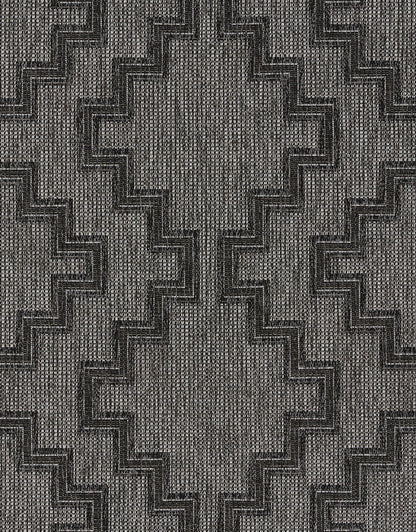 Charcoal gray and light gray woven rug with bold stepped zigzag chevron pattern and textured weave.