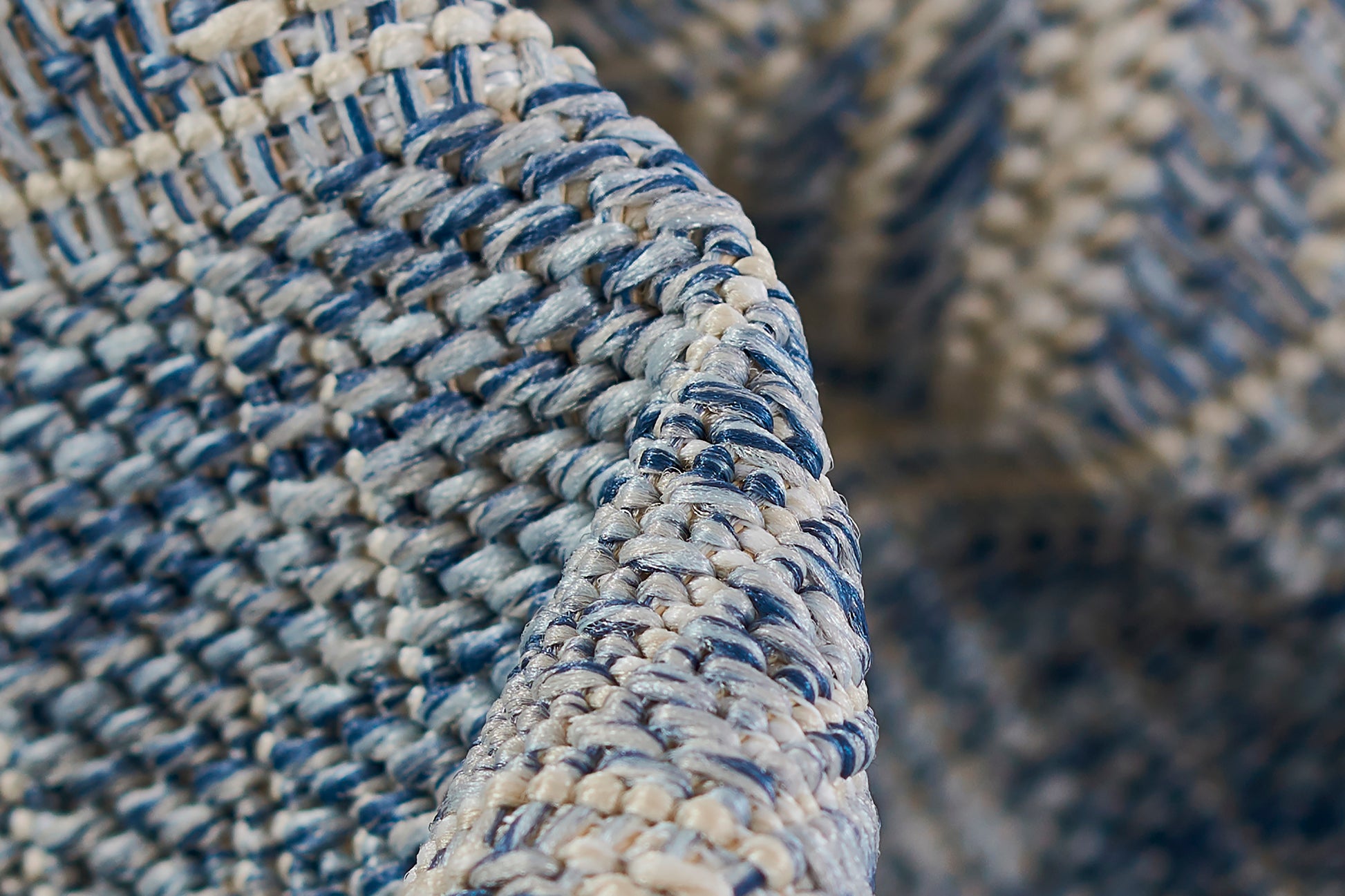 Blue & cream braided rug with a rounded edge; textured coastal weave; 8' x 10'.