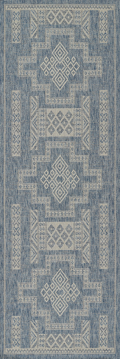 Blue and cream geometric woven rug, rectangular with diamond medallions and stepped borders, boho tribal style.