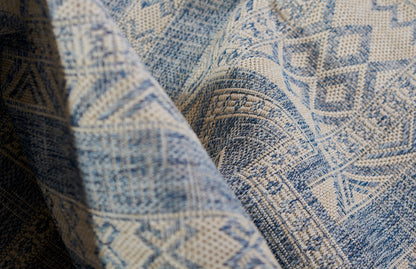 Blue and beige geometric woven rug with a textured jacquard pattern and thick weave.