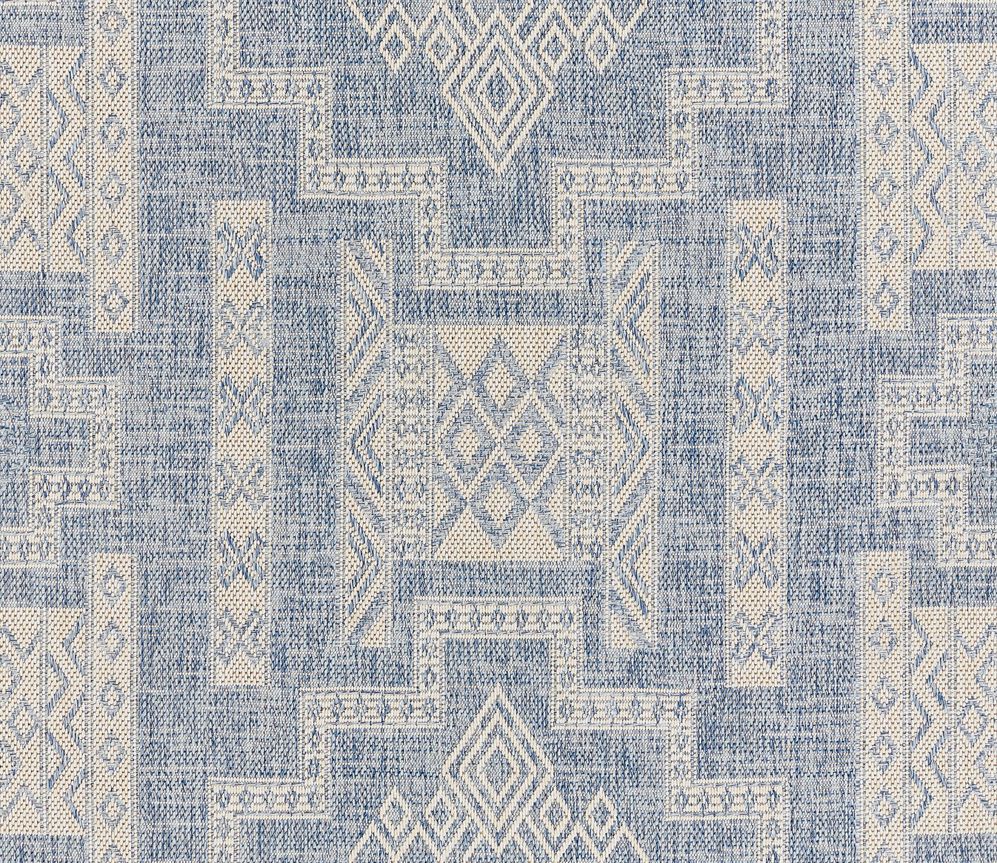 Blue & ivory geometric rug with diamond motifs & patchwork blocks, woven textile.