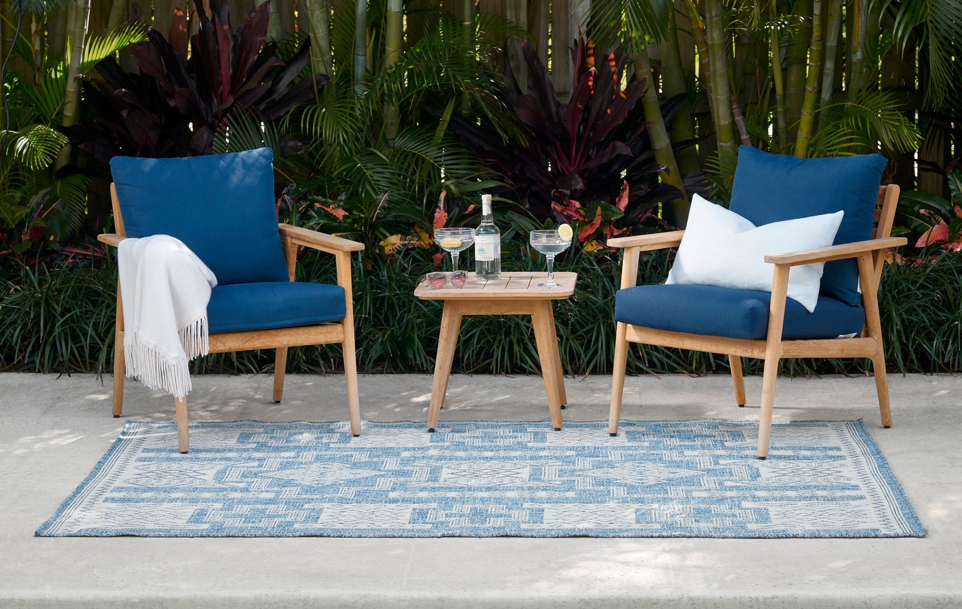 Outdoor rug with a blue patterned design.