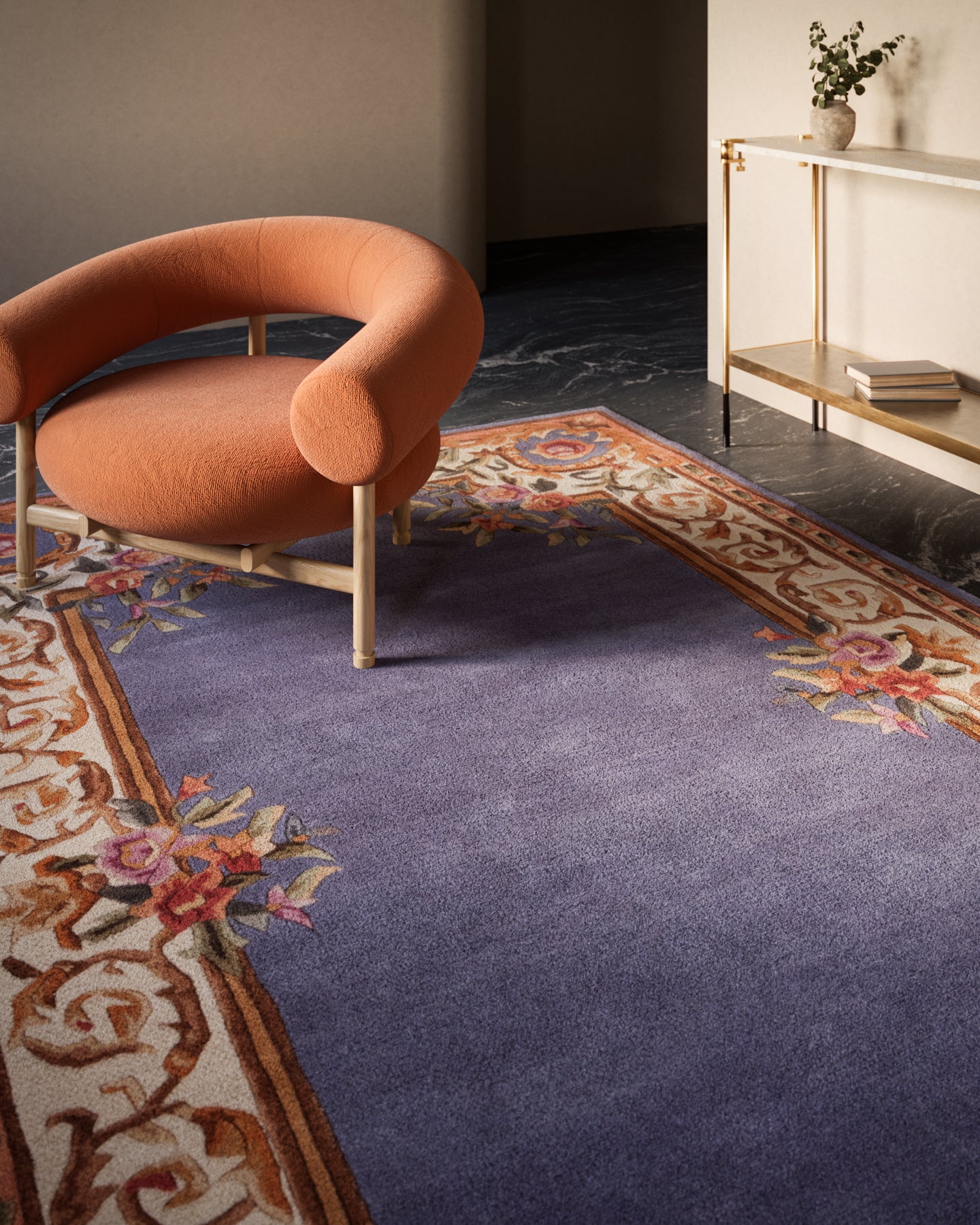 Round 4' rug with an ornate floral border in a modern living room.