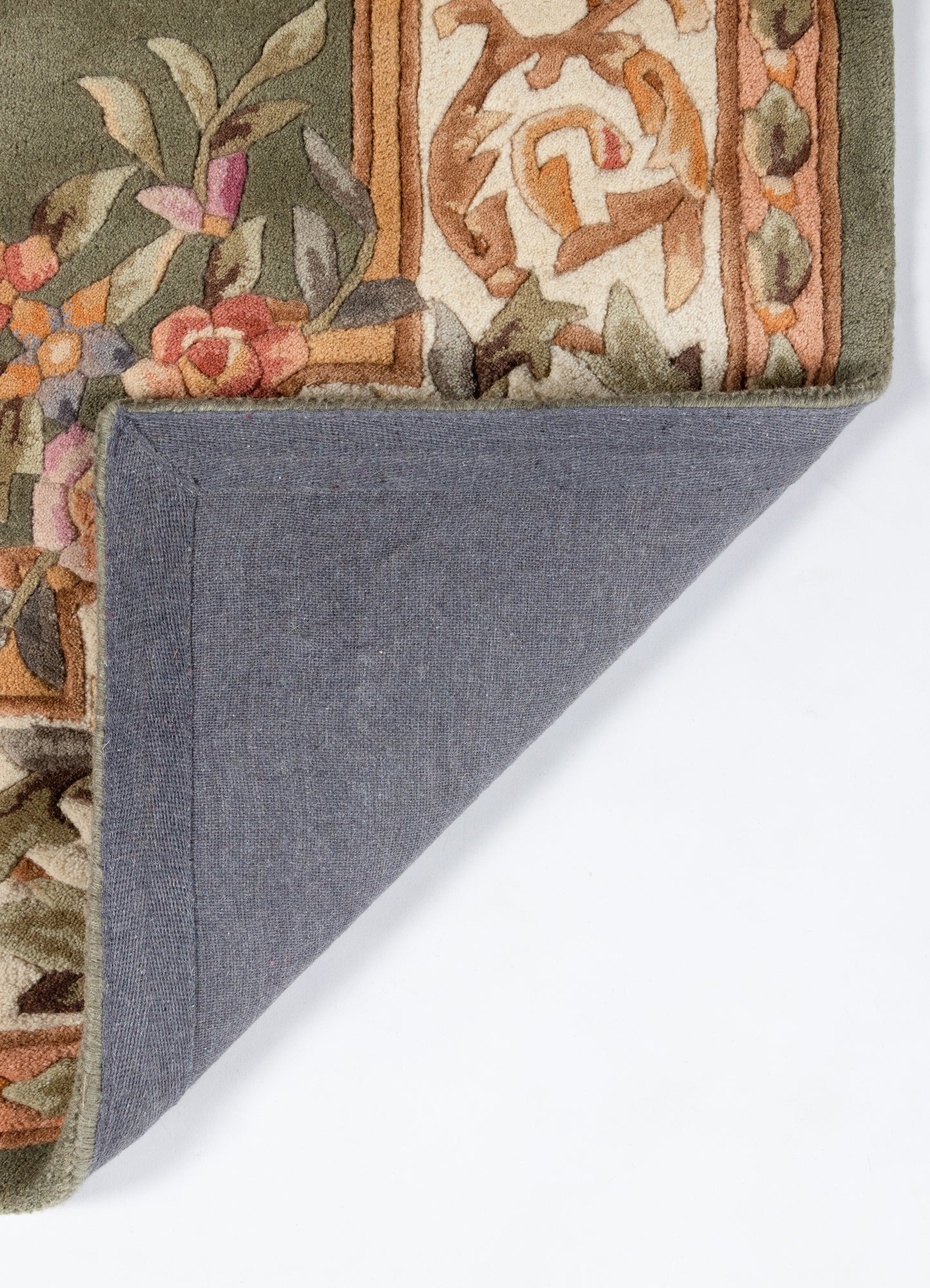 Floral rug with olive-green border and warm orange accents; corner folded to show blue fabric backing.