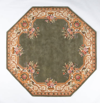 Oriental rug: olive-green center with peach floral border, pink and purple blossoms, decorative vine pattern.
