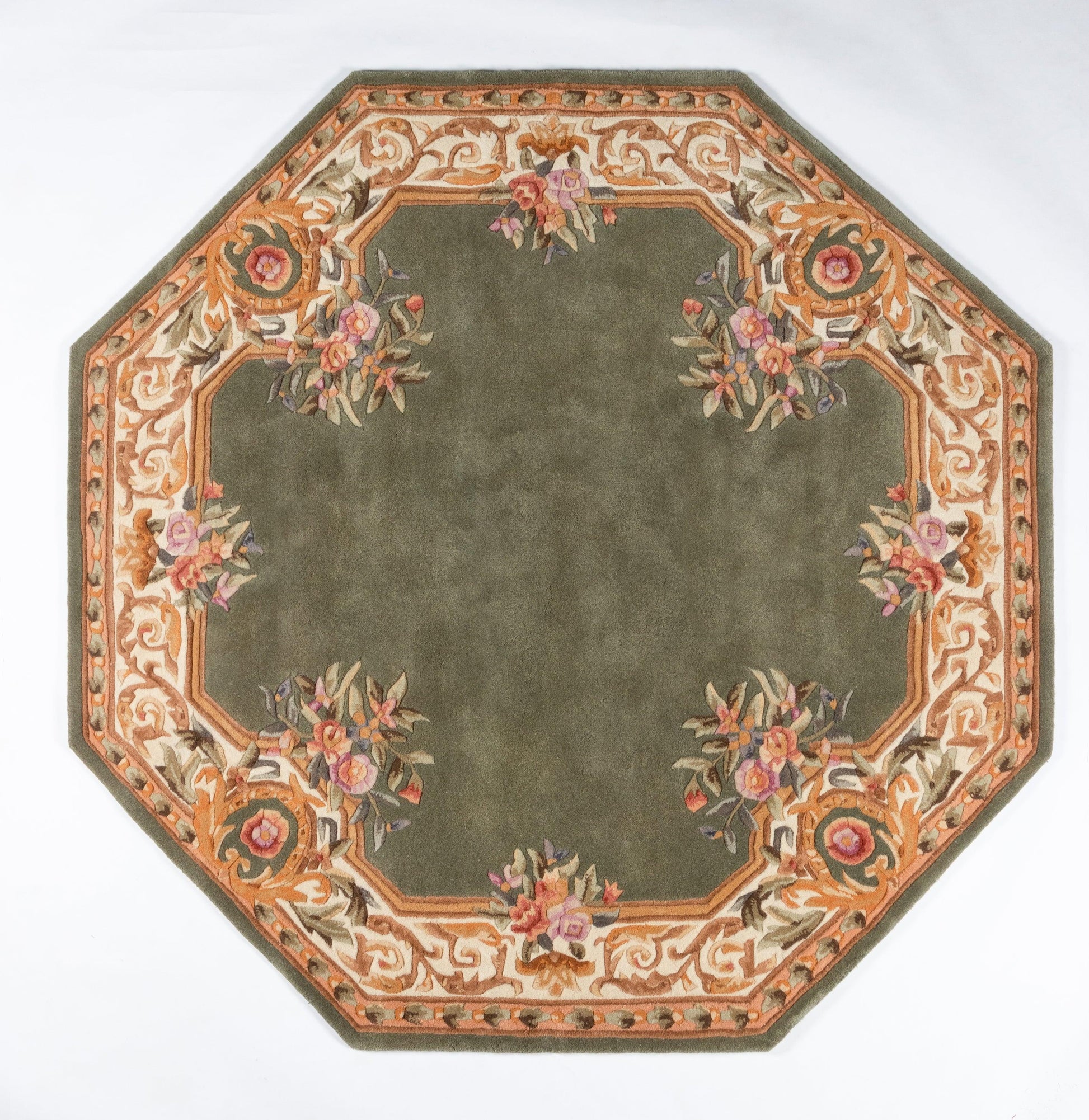 Octagonal oriental rug with olive-green center & ornate orange-beige floral border featuring pink bouquets.