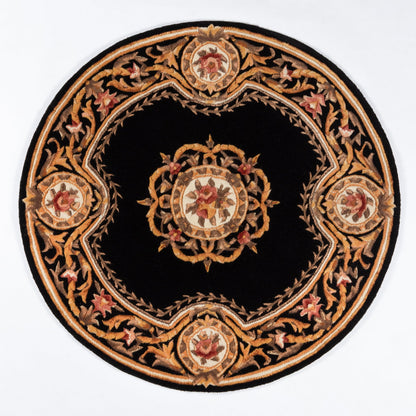 Round black rug with gold-tan ornate border and central medallion, red accents, Persian-inspired design.