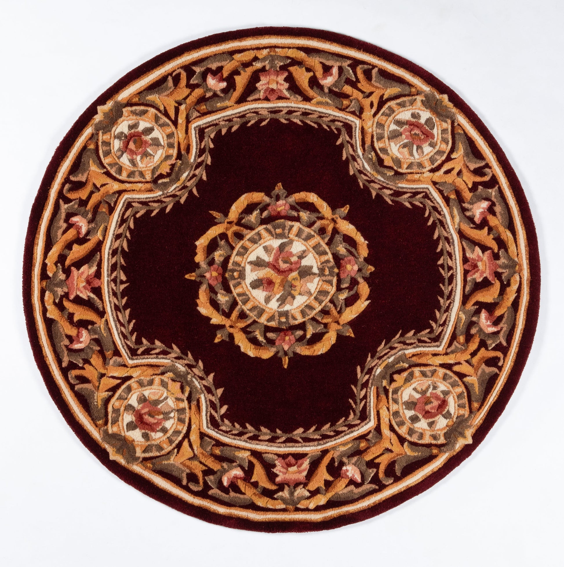 Circular burgundy rug with gold floral border and central medallion, ornate scrollwork and beige accents.