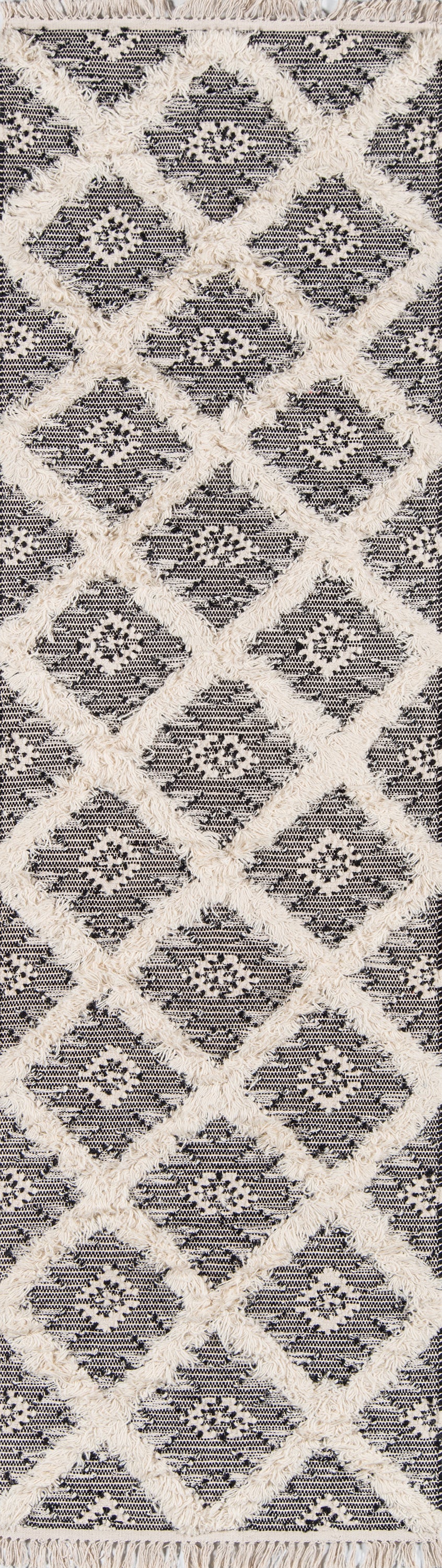 Ivory shaggy-diamond patterned rug with black & white lattice background; fringed edges, modern Moroccan style.
