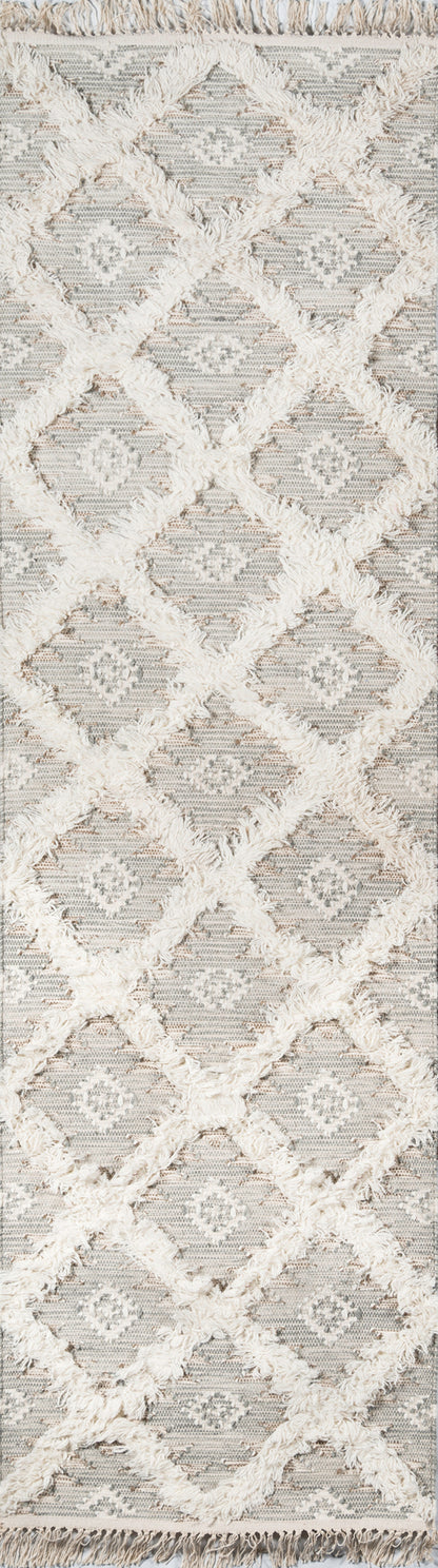 Gray rug with white fluffy diamond lattice pattern, textured weave and fringed edges.