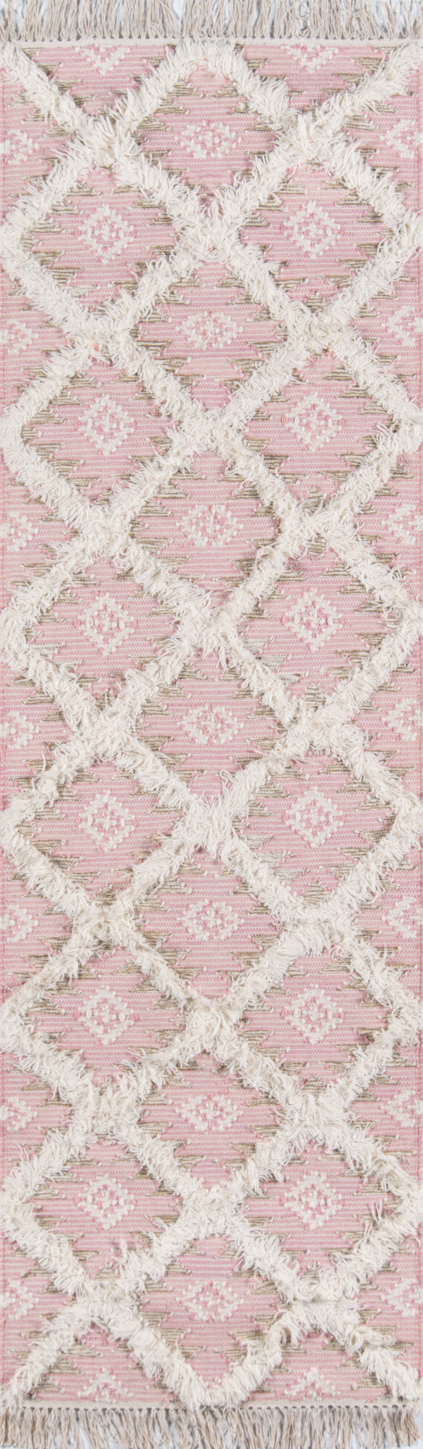 Soft pink shag rug with cream lattice diamond pattern and fringed edges, plush boho decor rug.
