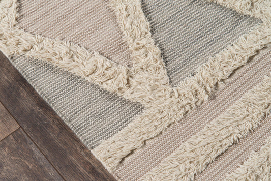 Harpehar striped shag rug with cream fringe, beige and gray bands on dark wood floor.