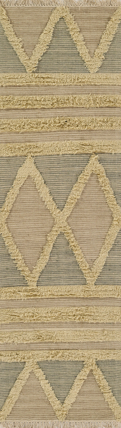 Beige woven rug with cream shaggy fringe and large chevron diamonds; rustic Moroccan/tribal style.