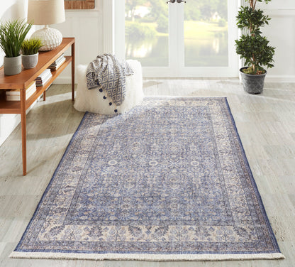 Rectangular blue and ivory oriental-style runner with an intricate medallion pattern and fringe, 3' x 8'.