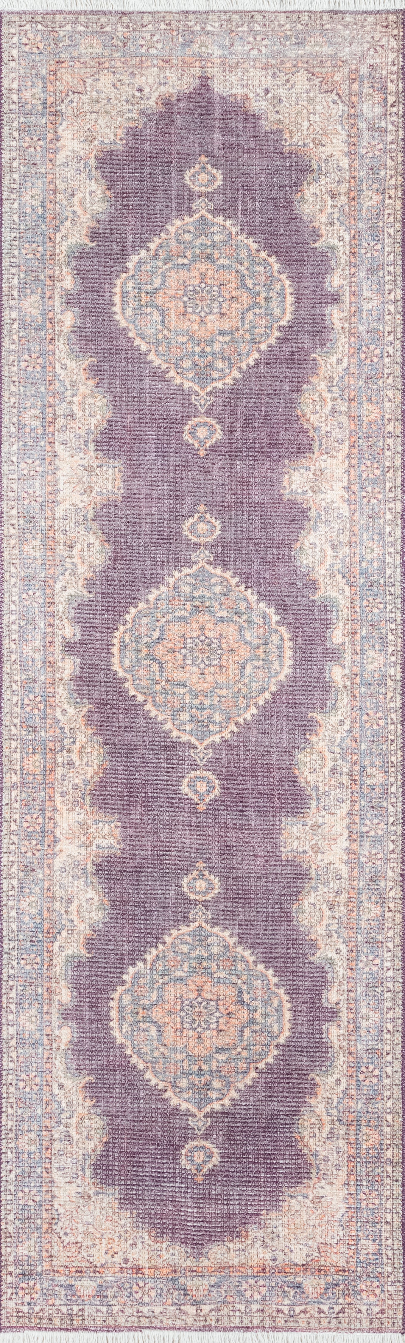 Persian-inspired runner rug with purple field, blue and peach medallion motifs, and pale beige border.